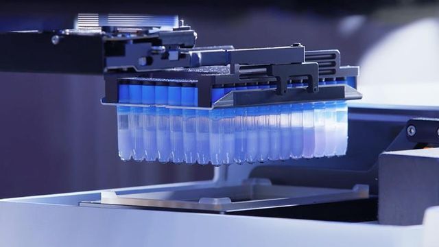 A liquid handling robot transfers samples into a 96-well plate 