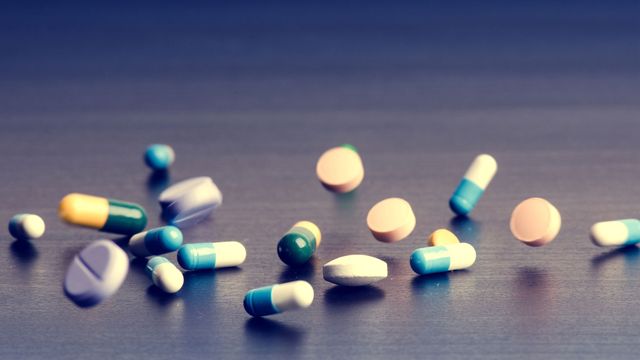 Various drug tablets on table 
