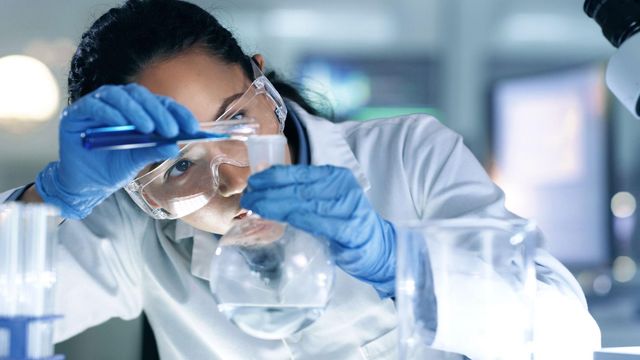 Thinking, focused and professional scientist doing research to create a cure in a research lab. 