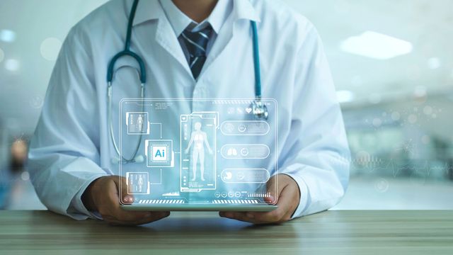 A doctor holding a tablet projecting a screen in the air. 