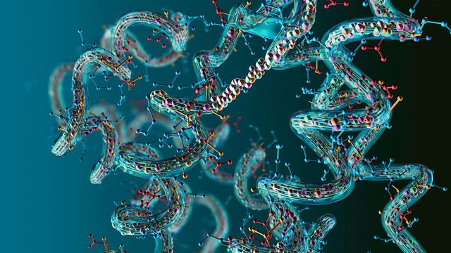 Abstract multicolored ball and stick model of a protein on a dark blue background. 